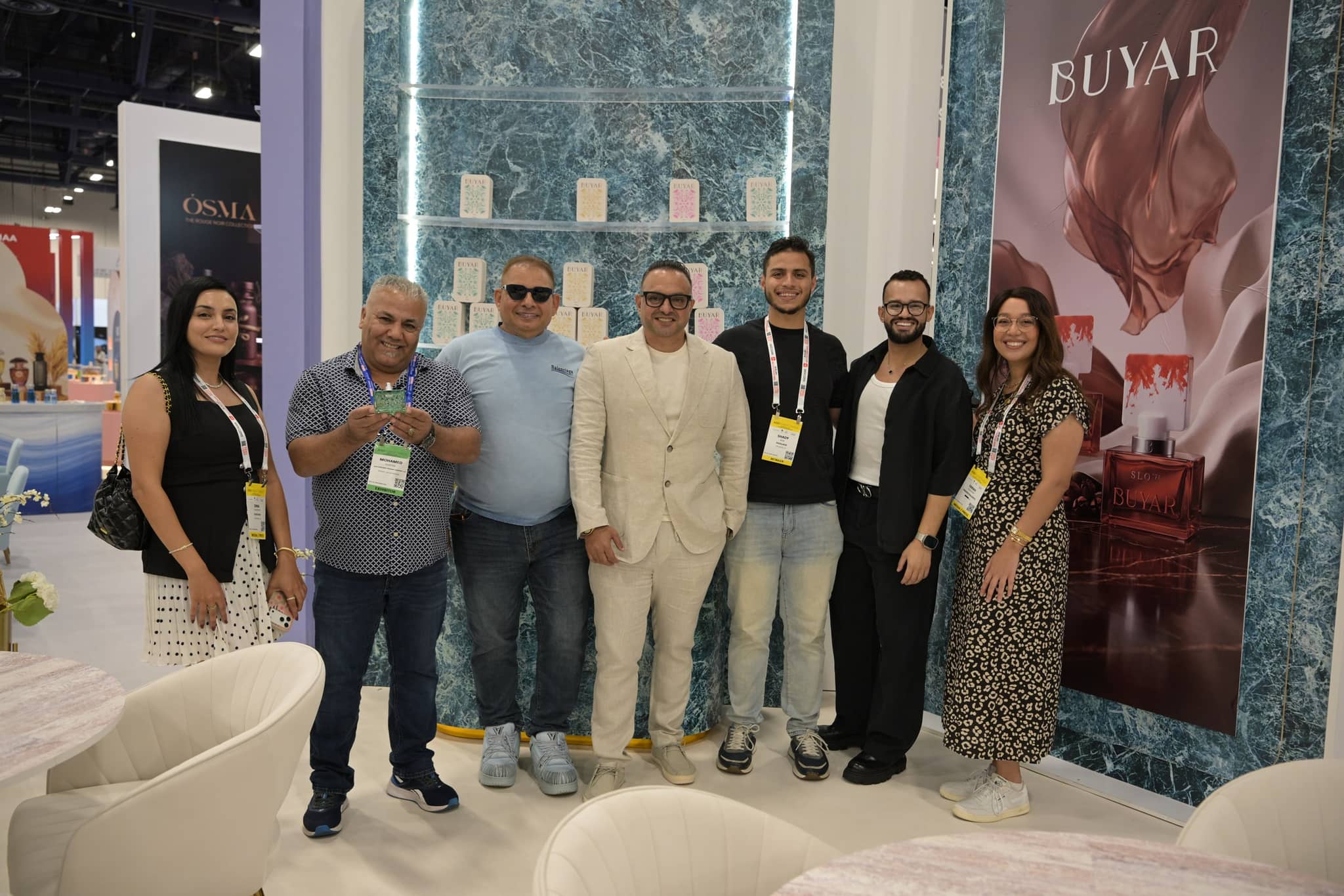 Exhibitor team posing together at the BUYAR fragrance booth