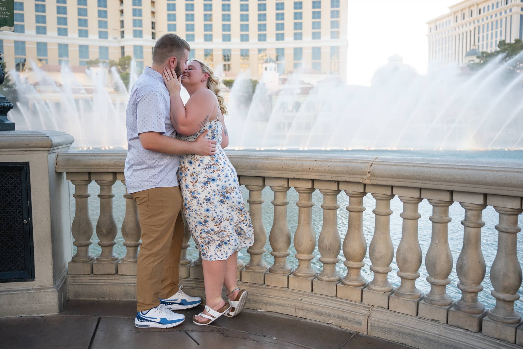 Couple kissing in front of the fountains on the Las Vegas Strip during their engagement session