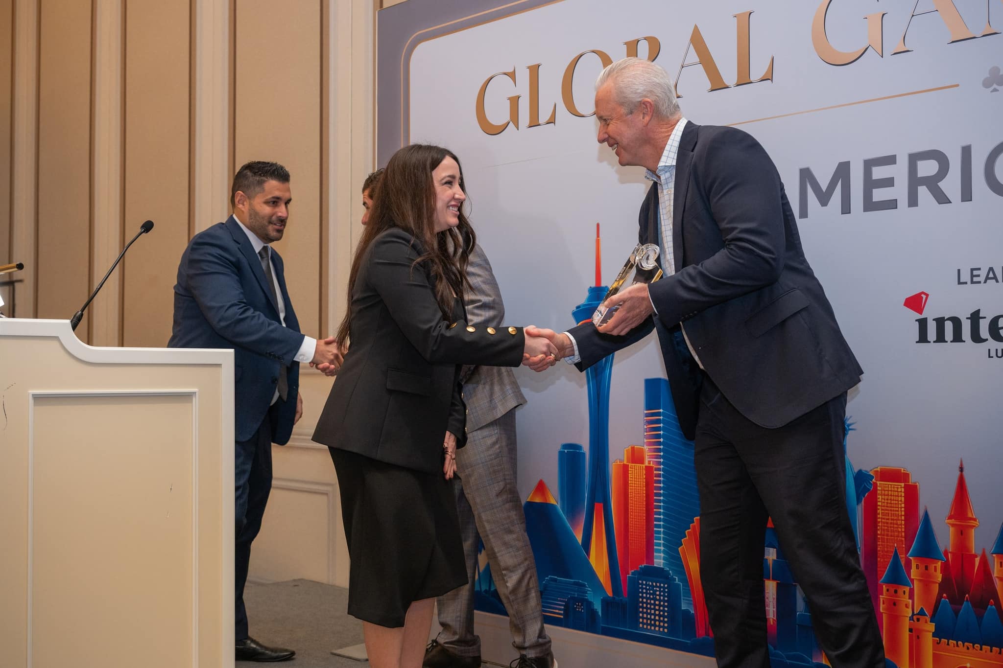Award recipient shaking hands with a presenter at the Global Gaming Awards Americas 2026