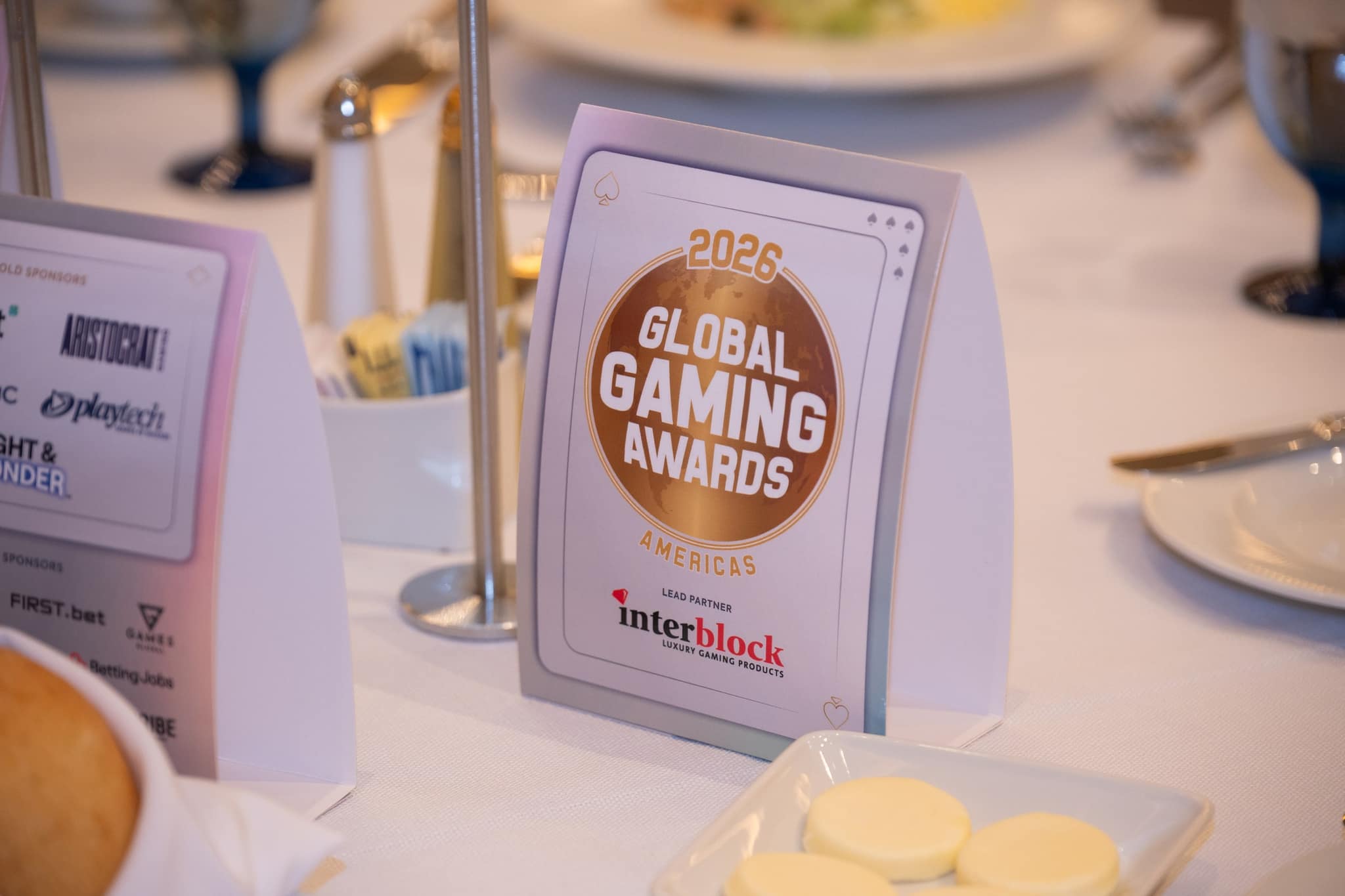 Branded table signage and place settings at the Global Gaming Awards Americas 2026