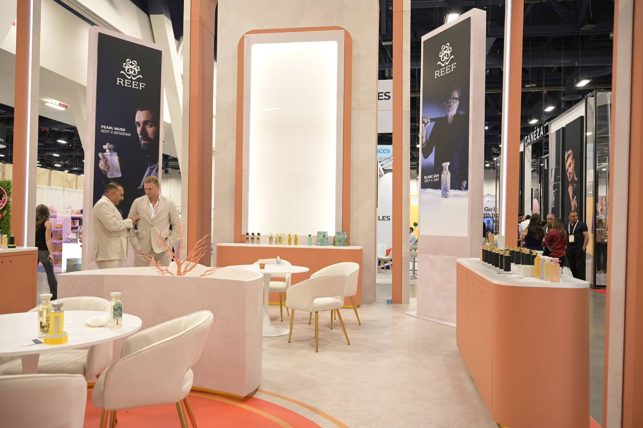 REEF booth interior with branded displays and meeting tables